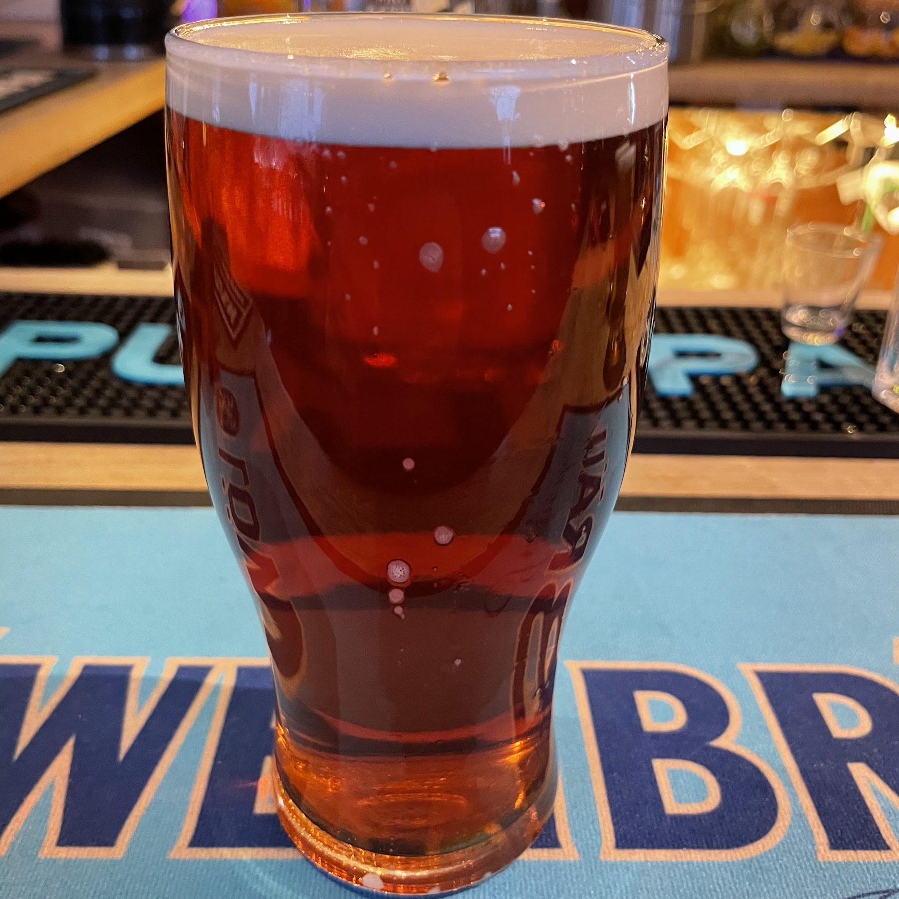 A pint of red ale on the bar